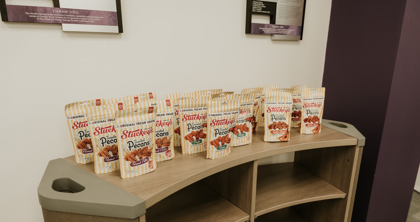 bags of Stuckey's toasted pecans in a row at the lecture reception